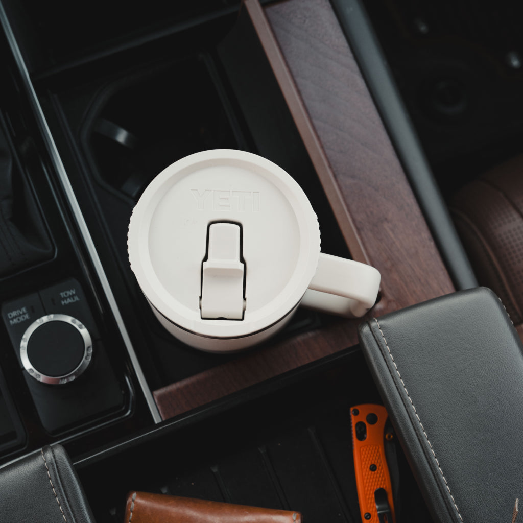 White Travel Straw Mug with a lid on a car's cup holder