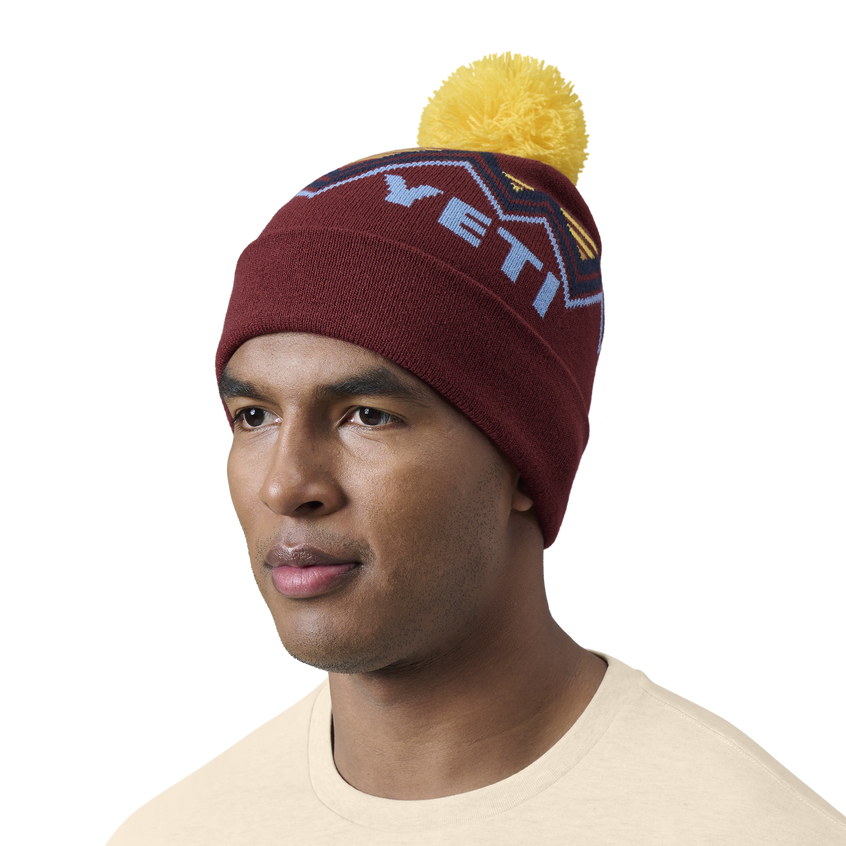 YETI Freestyle-beanie met pompon Rust/Yellow